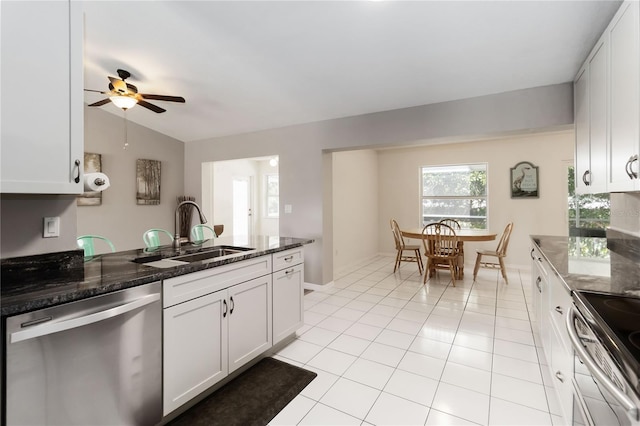 5 Bird Of Paradise Pl, Palm Coast, FL 32137 - kitchen featuring stainless steel appliances, ceiling fan, dark stone counters, white cabinets, and light tile patterned flooring