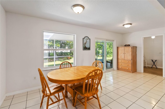 5 Bird Of Paradise Pl, Palm Coast, FL 32137 - dining space with light tile patterned floors and a textured ceiling