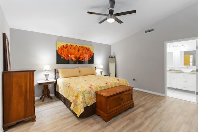 5 Bird Of Paradise Pl, Palm Coast, FL 32137 - bedroom with lofted ceiling, light wood-style flooring, ensuite bath, and ceiling fan