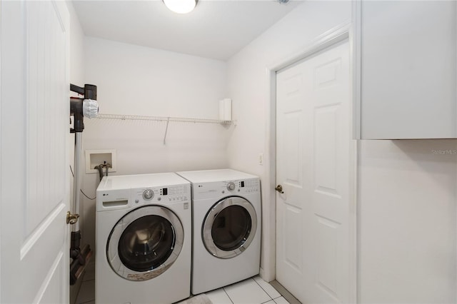 5 Bird Of Paradise Pl, Palm Coast, FL 32137 - laundry area with washer and clothes dryer and light tile patterned floors