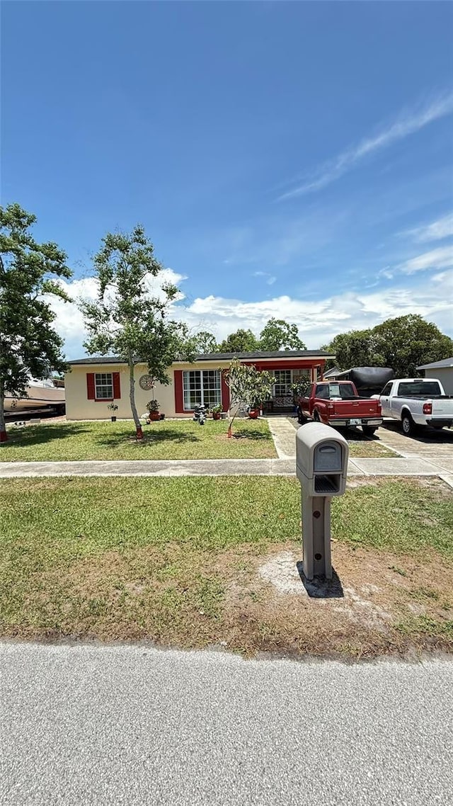 1025 Persian St, Deltona, FL 32725 - ranch-style home featuring a front yard and driveway