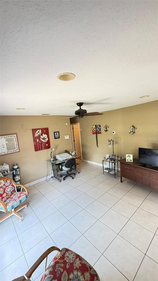 1025 Persian St, Deltona, FL 32725 - living room with a textured ceiling, light tile patterned floors, and ceiling fan
