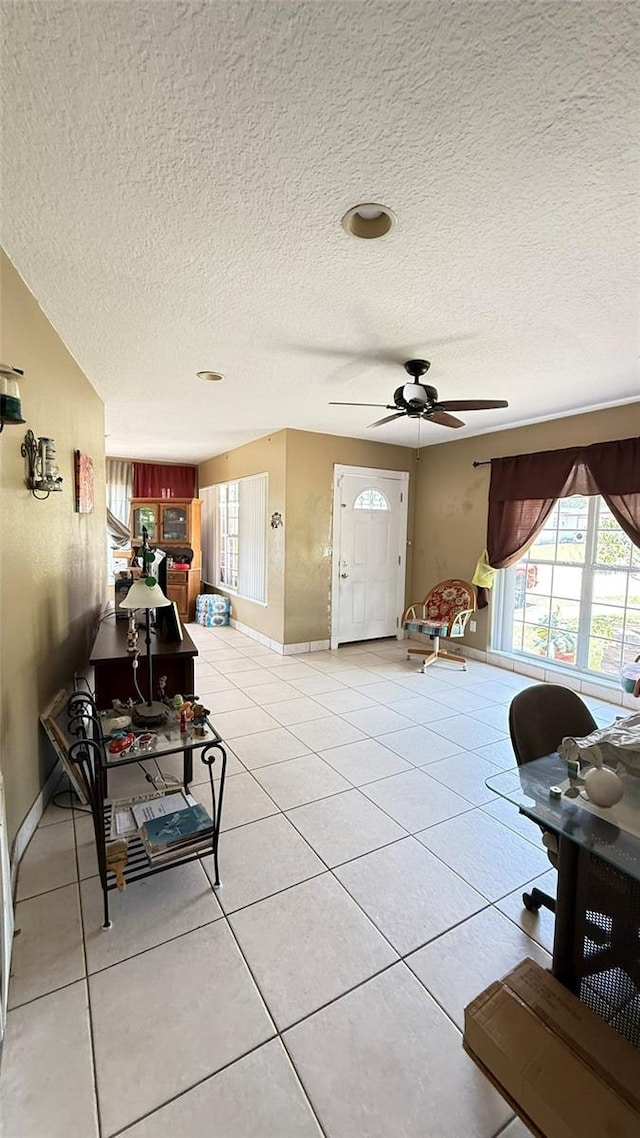 1025 Persian St, Deltona, FL 32725 - living room with a textured ceiling, a ceiling fan, and light tile patterned floors