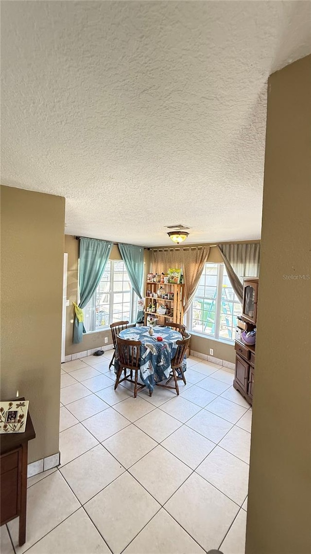 1025 Persian St, Deltona, FL 32725 - dining space featuring light tile patterned flooring and a textured ceiling