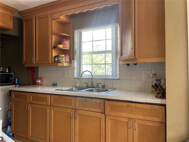 1025 Persian St, Deltona, FL 32725 - kitchen with backsplash, tile countertops, black microwave, and open shelves