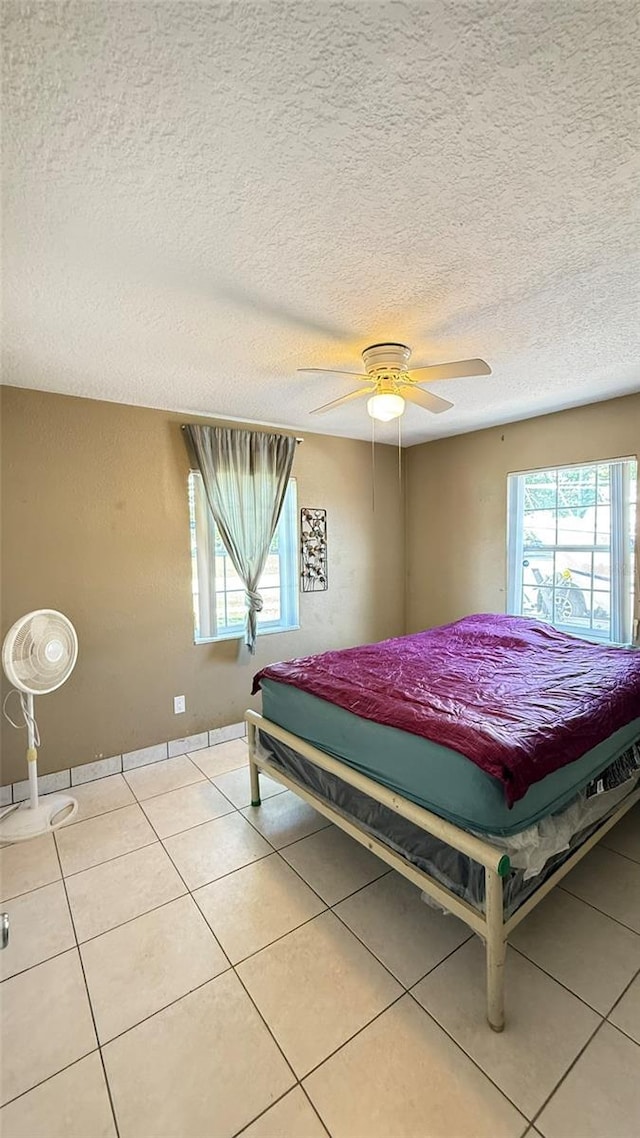 1025 Persian St, Deltona, FL 32725 - tiled bedroom with multiple windows, a textured ceiling, and ceiling fan