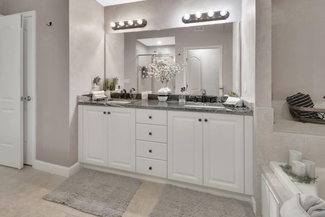 424 Luna Bella Ln Unit 330, New Smyrna Beach, FL 32168 - bathroom featuring double vanity, tile patterned flooring, and a tub
