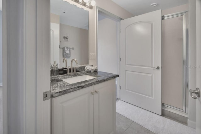 424 Luna Bella Ln Unit 330, New Smyrna Beach, FL 32168 - bathroom with vanity, a stall shower, and tile patterned floors