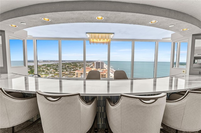 2545 S Atlantic Ave Unit 102, Daytona Beach Shores, FL 32118 - dining room featuring a water view, healthy amount of natural light, and recessed lighting