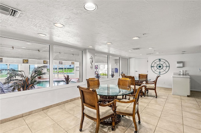 2545 S Atlantic Ave Unit 102, Daytona Beach Shores, FL 32118 - dining room featuring light tile patterned flooring, plenty of natural light, recessed lighting, and a textured ceiling