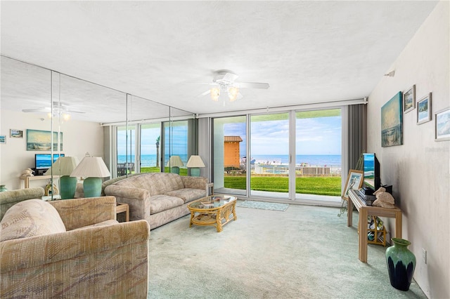 2545 S Atlantic Ave Unit 102, Daytona Beach Shores, FL 32118 - carpeted living room featuring a ceiling fan and floor to ceiling windows