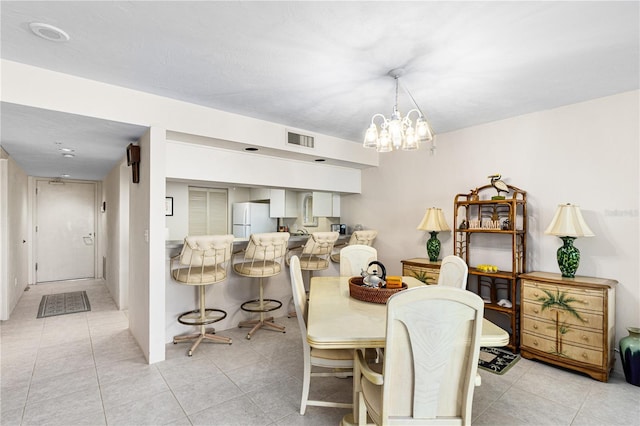 2545 S Atlantic Ave Unit 102, Daytona Beach Shores, FL 32118 - dining space featuring light tile patterned floors and a chandelier