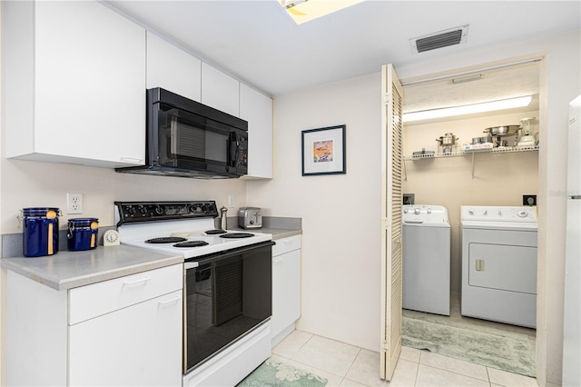 2545 S Atlantic Ave Unit 102, Daytona Beach Shores, FL 32118 - kitchen featuring electric range, black microwave, washer and clothes dryer, light countertops, and white cabinets