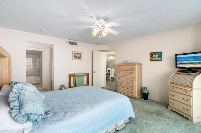 2545 S Atlantic Ave Unit 102, Daytona Beach Shores, FL 32118 - bedroom with light carpet, ceiling fan, and connected bathroom