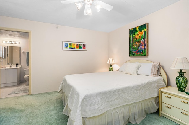 2545 S Atlantic Ave Unit 102, Daytona Beach Shores, FL 32118 - bedroom featuring light colored carpet, ensuite bath, and ceiling fan