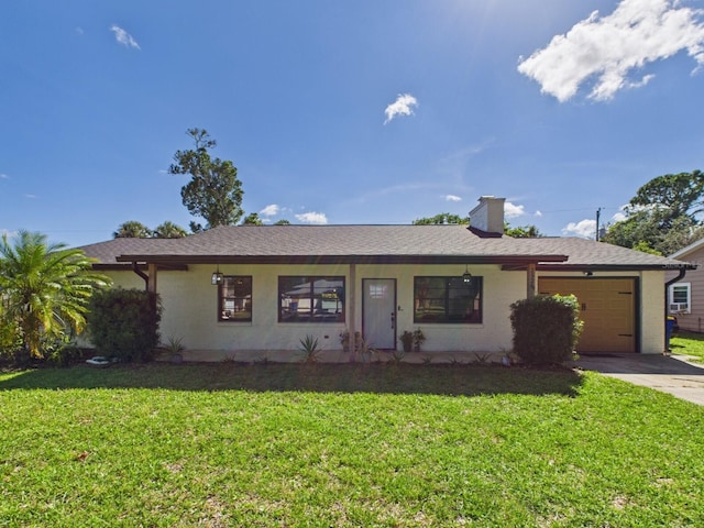 2526 Victory Palm Dr, Edgewater, FL 32141 - ranch-style house featuring an attached garage, concrete driveway, a front yard, a chimney, and stucco siding