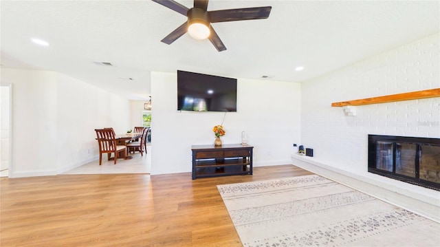 2526 Victory Palm Dr, Edgewater, FL 32141 - living room featuring light wood-style flooring, a fireplace, ceiling fan, and recessed lighting