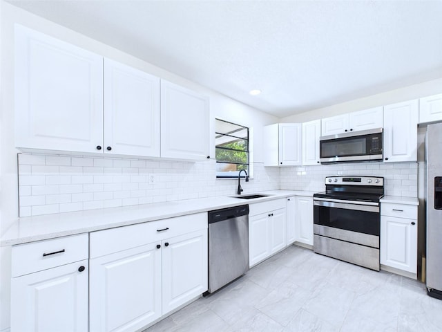 2526 Victory Palm Dr, Edgewater, FL 32141 - kitchen with appliances with stainless steel finishes, white cabinetry, backsplash, and light countertops
