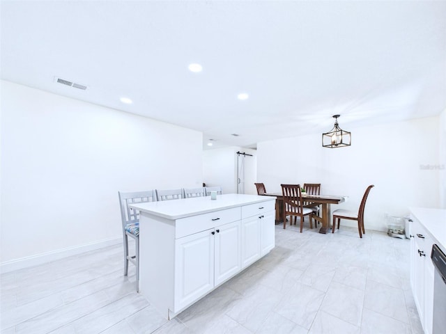 2526 Victory Palm Dr, Edgewater, FL 32141 - kitchen with light countertops, a kitchen island, white cabinets, pendant lighting, and dishwasher