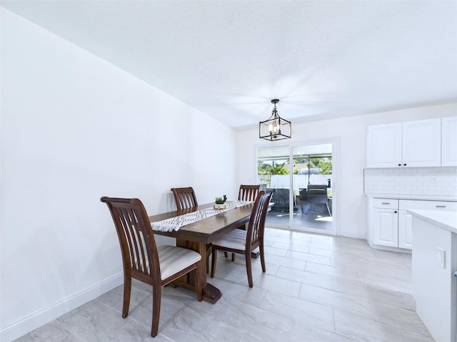 2526 Victory Palm Dr, Edgewater, FL 32141 - dining space featuring a chandelier and baseboards