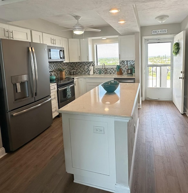 2860 Ocean Shore Blvd Unit 5020, Ormond Beach, FL 32176 - kitchen featuring appliances with stainless steel finishes, decorative backsplash, white cabinets, a textured ceiling, and recessed lighting