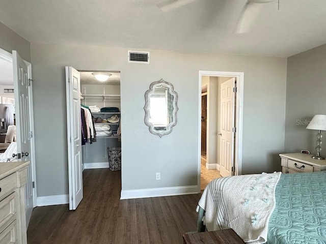 2860 Ocean Shore Blvd Unit 5020, Ormond Beach, FL 32176 - bedroom with a walk in closet, dark wood-style floors, a closet, and stainless steel refrigerator with ice dispenser