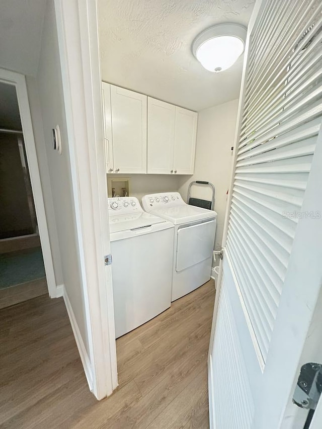2860 Ocean Shore Blvd Unit 5020, Ormond Beach, FL 32176 - laundry area featuring cabinet space, independent washer and dryer, and light wood-style flooring