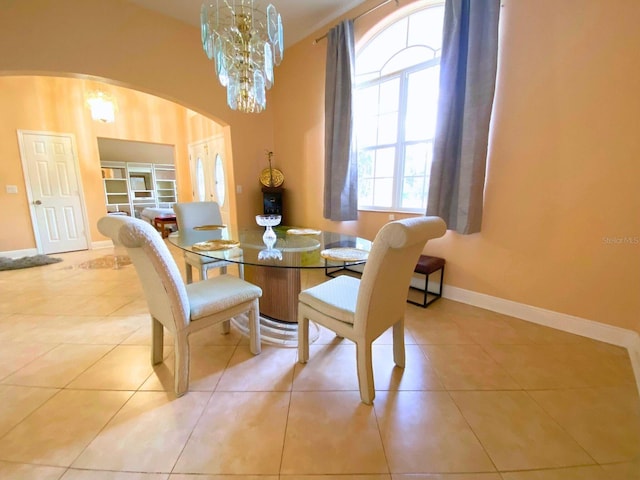 19320 Oberly Pkwy, Orlando, FL 32833 - tiled dining area featuring arched walkways, a chandelier, and built in shelves
