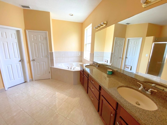 19320 Oberly Pkwy, Orlando, FL 32833 - bathroom with a bath, double vanity, a shower stall, and tile patterned floors