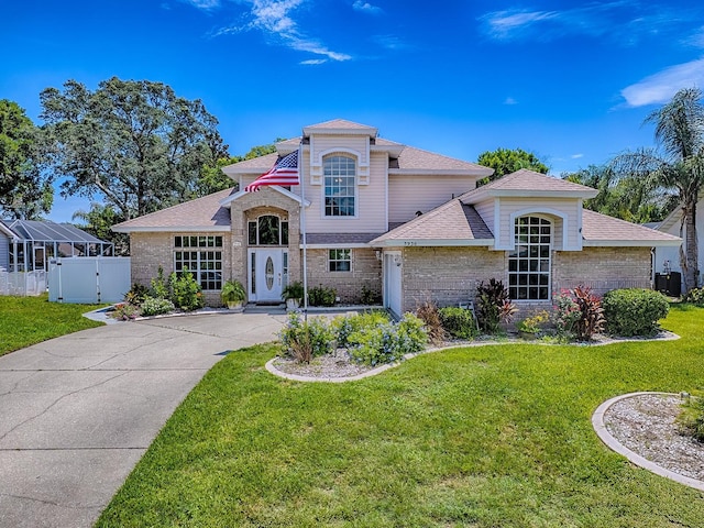 5936 Boggs Ford Rd, Port Orange, FL 32127 - view of front of house featuring brick siding, a gate, roof with shingles, and concrete driveway
