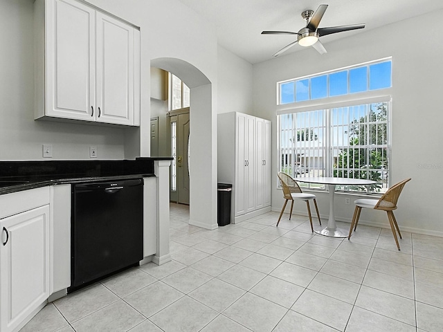 5936 Boggs Ford Rd, Port Orange, FL 32127 - kitchen featuring black dishwasher, dark countertops, arched walkways, white cabinetry, and a high ceiling