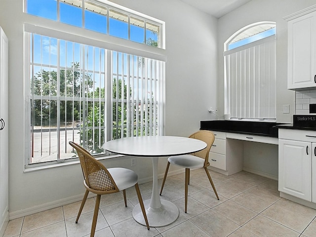 5936 Boggs Ford Rd, Port Orange, FL 32127 - dining room featuring light tile patterned floors and baseboards