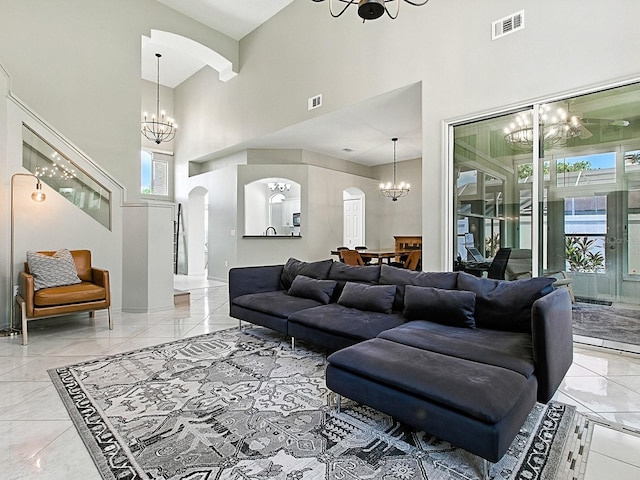 5936 Boggs Ford Rd, Port Orange, FL 32127 - living room featuring arched walkways, a chandelier, a towering ceiling, and marble tiled flooring