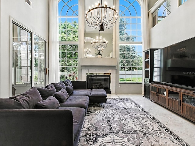 5936 Boggs Ford Rd, Port Orange, FL 32127 - living area featuring a chandelier, plenty of natural light, a glass covered fireplace, and a high ceiling
