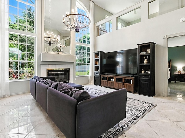 5936 Boggs Ford Rd, Port Orange, FL 32127 - tiled living room with a chandelier, plenty of natural light, a tiled fireplace, and a high ceiling