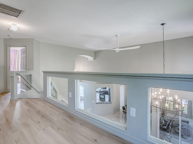 5936 Boggs Ford Rd, Port Orange, FL 32127 - corridor with wood finished floors, a chandelier, and arched walkways