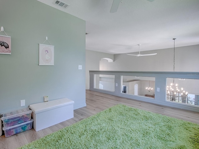 5936 Boggs Ford Rd, Port Orange, FL 32127 - living room with ceiling fan, wood finished floors, arched walkways, and a chandelier