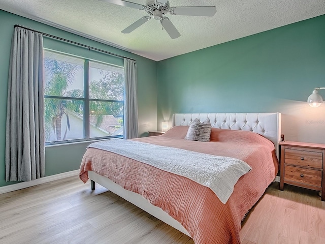 5936 Boggs Ford Rd, Port Orange, FL 32127 - bedroom with wood finished floors, ceiling fan, and a textured ceiling