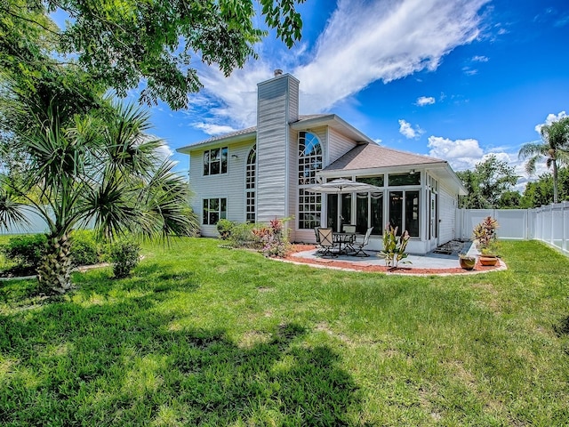 5936 Boggs Ford Rd, Port Orange, FL 32127 - back of house featuring a chimney, a patio area, and a sunroom