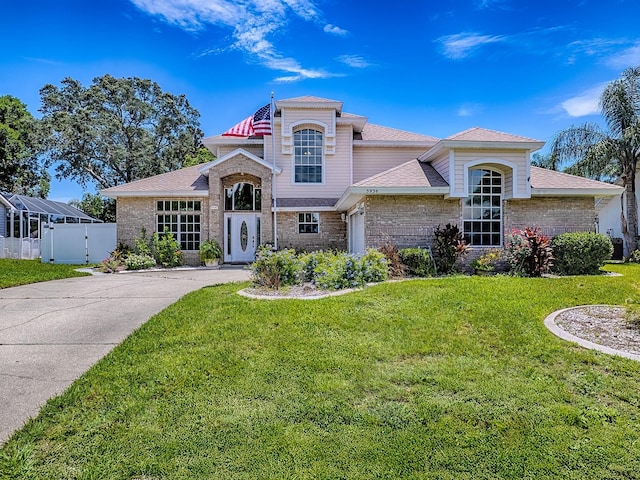 5936 Boggs Ford Rd, Port Orange, FL 32127 - view of front facade featuring brick siding, a gate, roof with shingles, and concrete driveway