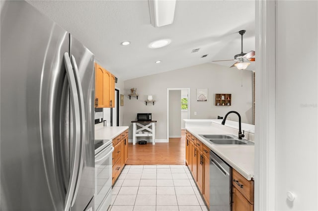 2455 Whooping Crane Dr, De Leon Springs, FL 32130 - kitchen featuring stainless steel appliances, vaulted ceiling, light countertops, light tile patterned floors, and ceiling fan