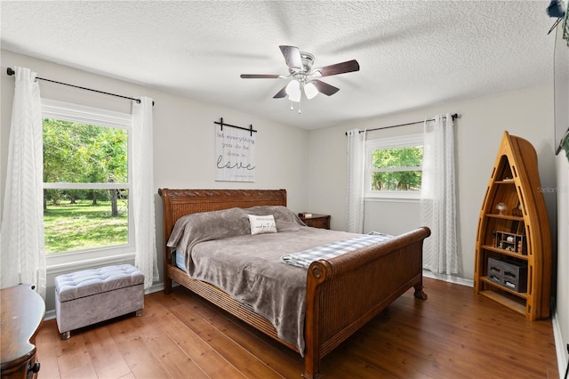 2455 Whooping Crane Dr, De Leon Springs, FL 32130 - bedroom with light wood-style flooring, ceiling fan, and a textured ceiling
