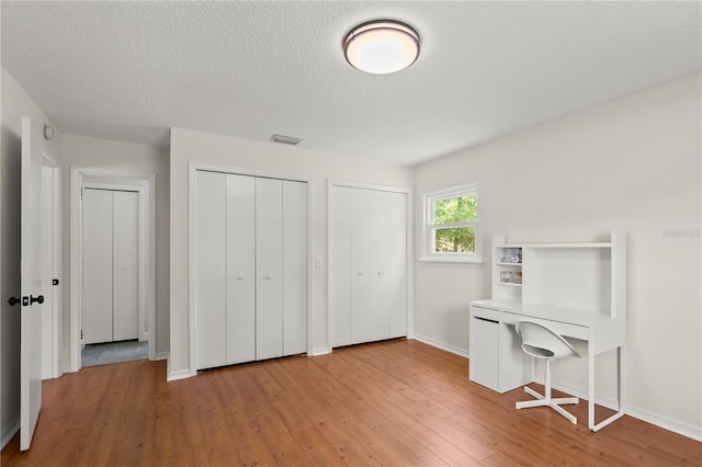 2455 Whooping Crane Dr, De Leon Springs, FL 32130 - home office with hardwood / wood-style floors and a textured ceiling