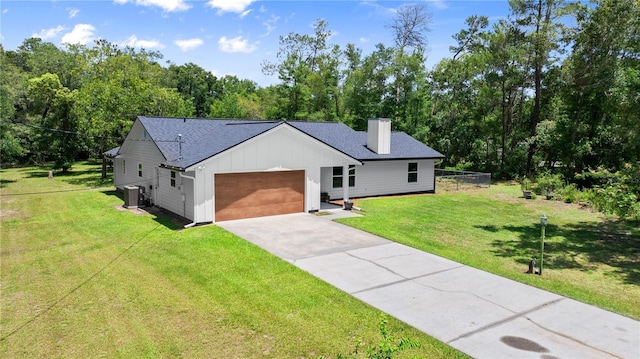2455 Whooping Crane Dr, De Leon Springs, FL 32130 - modern inspired farmhouse featuring board and batten siding, a chimney, an attached garage, concrete driveway, and a front lawn