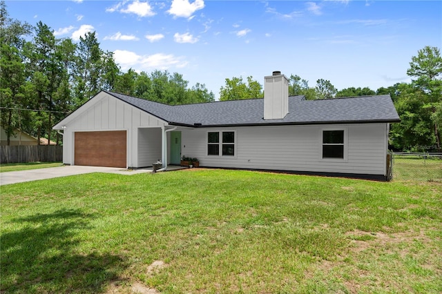 2455 Whooping Crane Dr, De Leon Springs, FL 32130 - view of front of house with concrete driveway, a chimney, an attached garage, and board and batten siding
