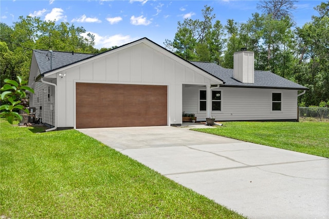 2455 Whooping Crane Dr, De Leon Springs, FL 32130 - view of front of home with a garage, a chimney, concrete driveway, and a shingled roof