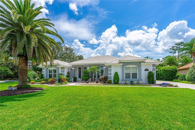 801 Arbor Glen Ct, Ormond Beach, FL 32174 - mediterranean / spanish home with stucco siding, a front yard, and a tiled roof
