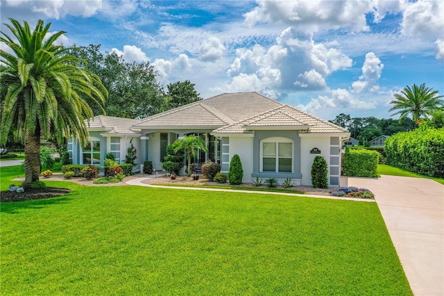 801 Arbor Glen Ct, Ormond Beach, FL 32174 - mediterranean / spanish-style home featuring a front yard, stucco siding, concrete driveway, and a tiled roof