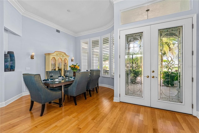 801 Arbor Glen Ct, Ormond Beach, FL 32174 - dining space featuring french doors, crown molding, and light wood finished floors