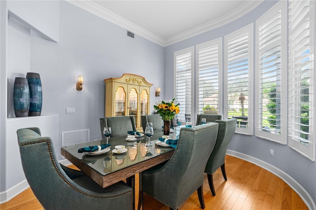801 Arbor Glen Ct, Ormond Beach, FL 32174 - dining room with plenty of natural light, ornamental molding, and light wood-style flooring